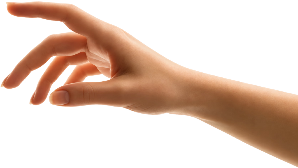 A hand reaching to receive the lamp