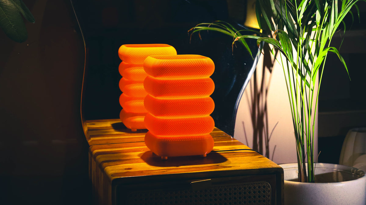 Modern orange textured lamps illuminated, layered design, cozy tabletop styling