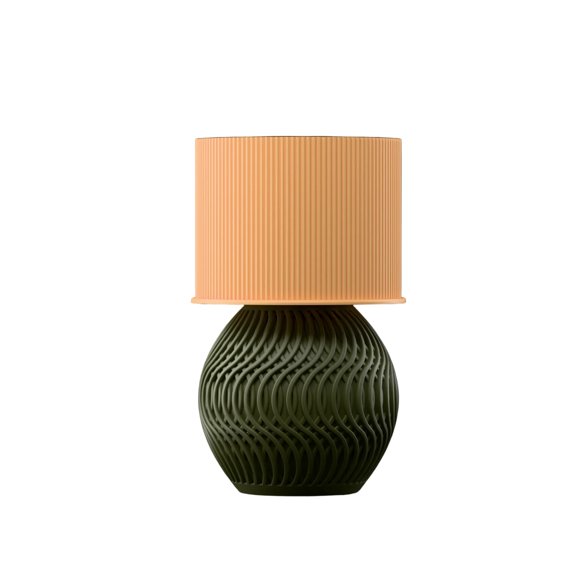 Table lamp with a textured green base and a peach lampshade on a white background