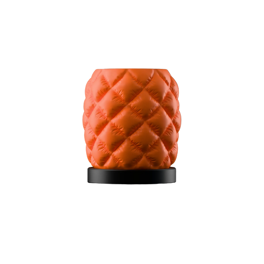Orange quilted table lamp with diamond puffer pattern and black base