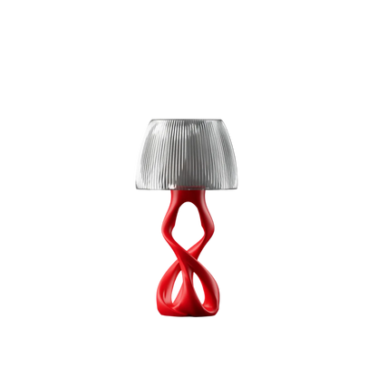 Modern table lamp with a red base and translucent shade on a white background