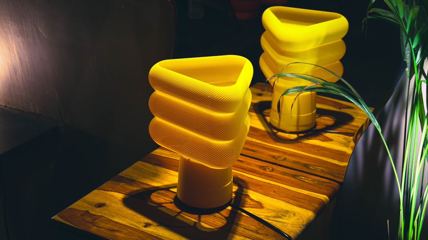 Textured yellow lamps with spiral triangular top, illuminated cozy setting