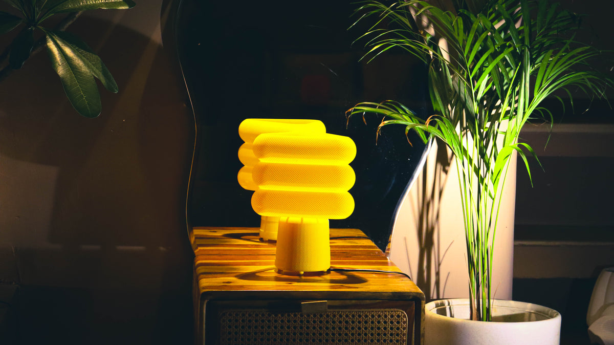 Bold yellow Trion table lamp, textured stacked rings, narrow stand