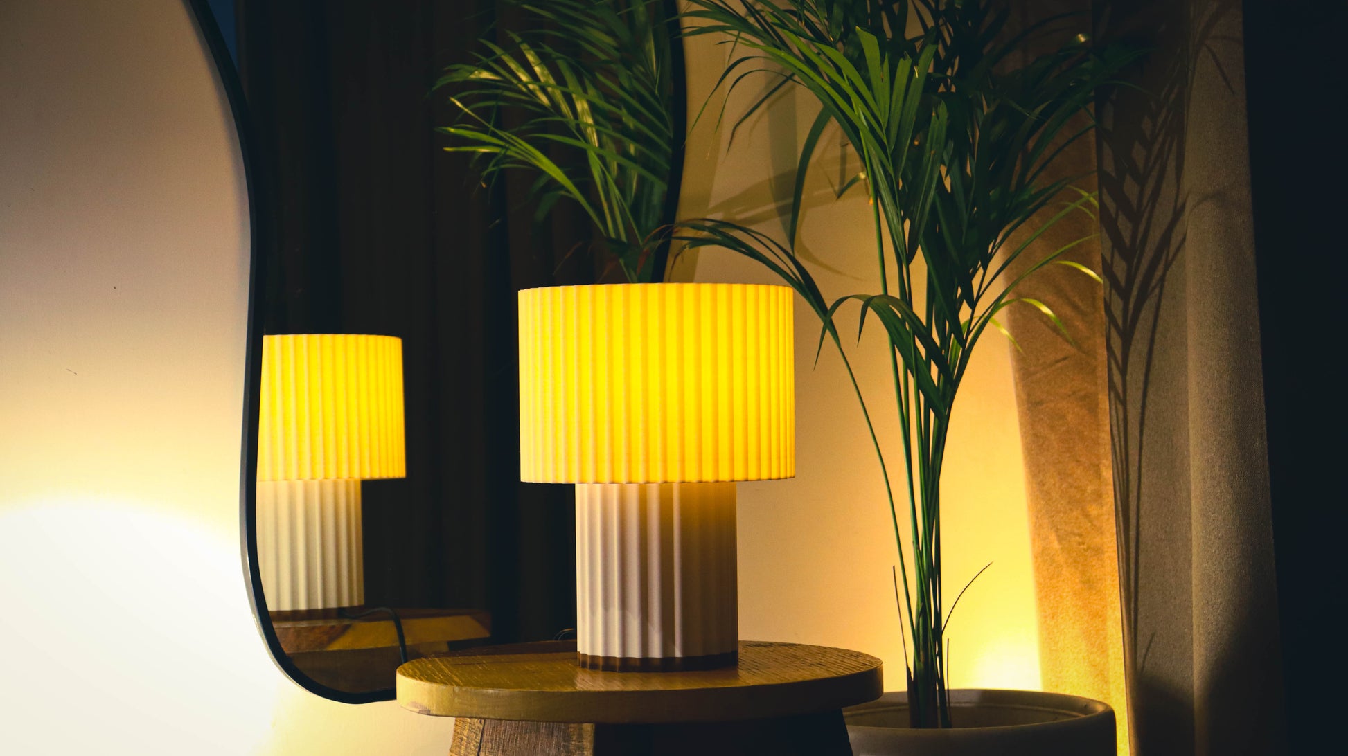 Ribbed drum table lamp with double-tier pleated design, warm ambient glow
