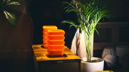 Modern orange textured lamps illuminated, layered ring design, cozy tabletop styling