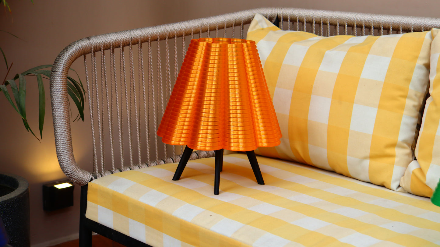 Orange ripple lamp on a striped sofa with a neutral background