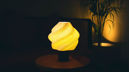 Soft serve table lamp illuminated at night, casting warm ambient light