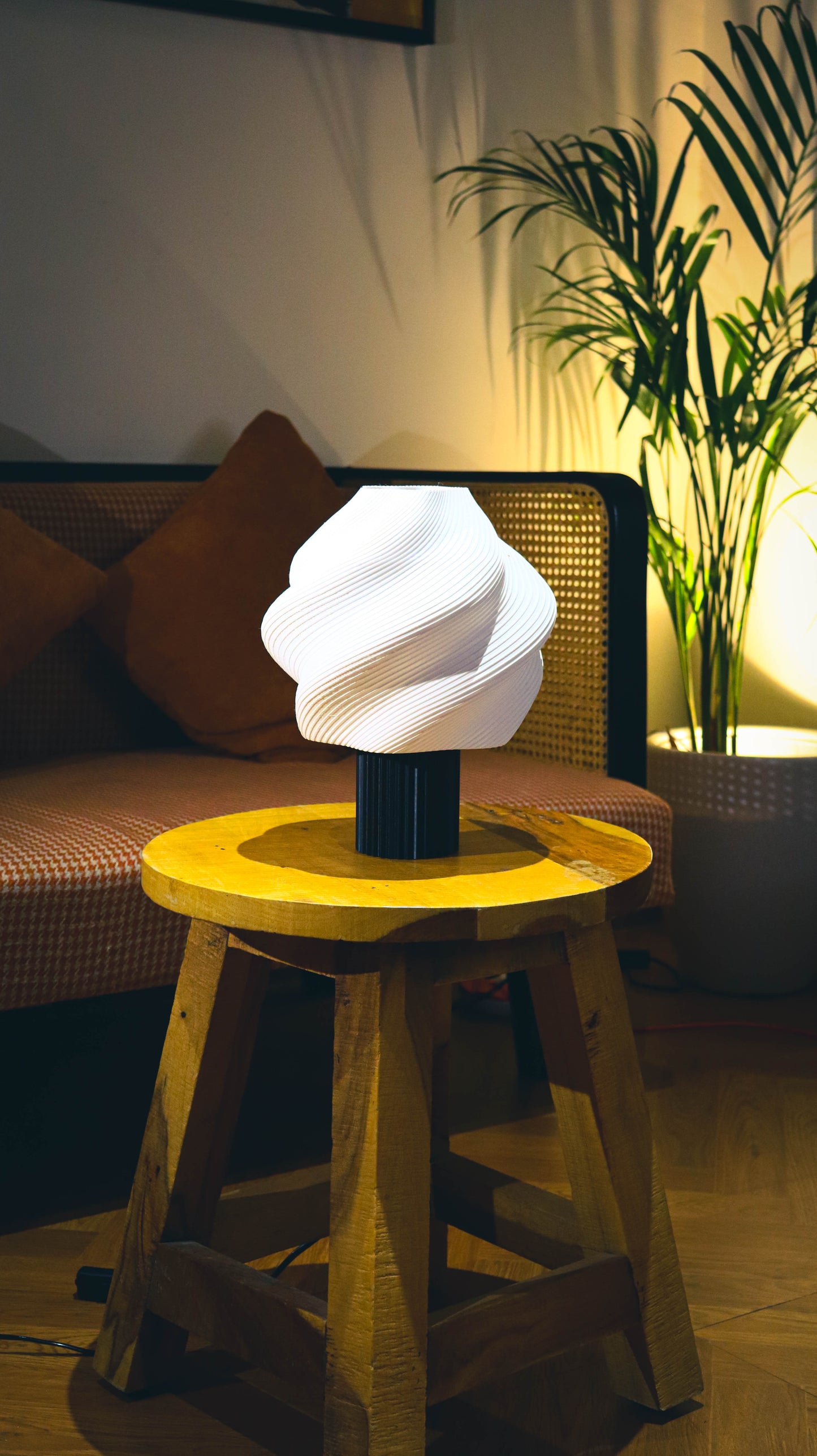 Modern lamp on a yellow stool in a cozy living room setting